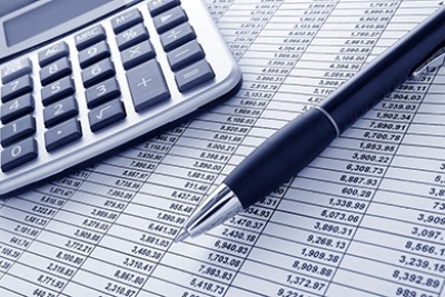Calculator and ledger representing managing electronic remittance